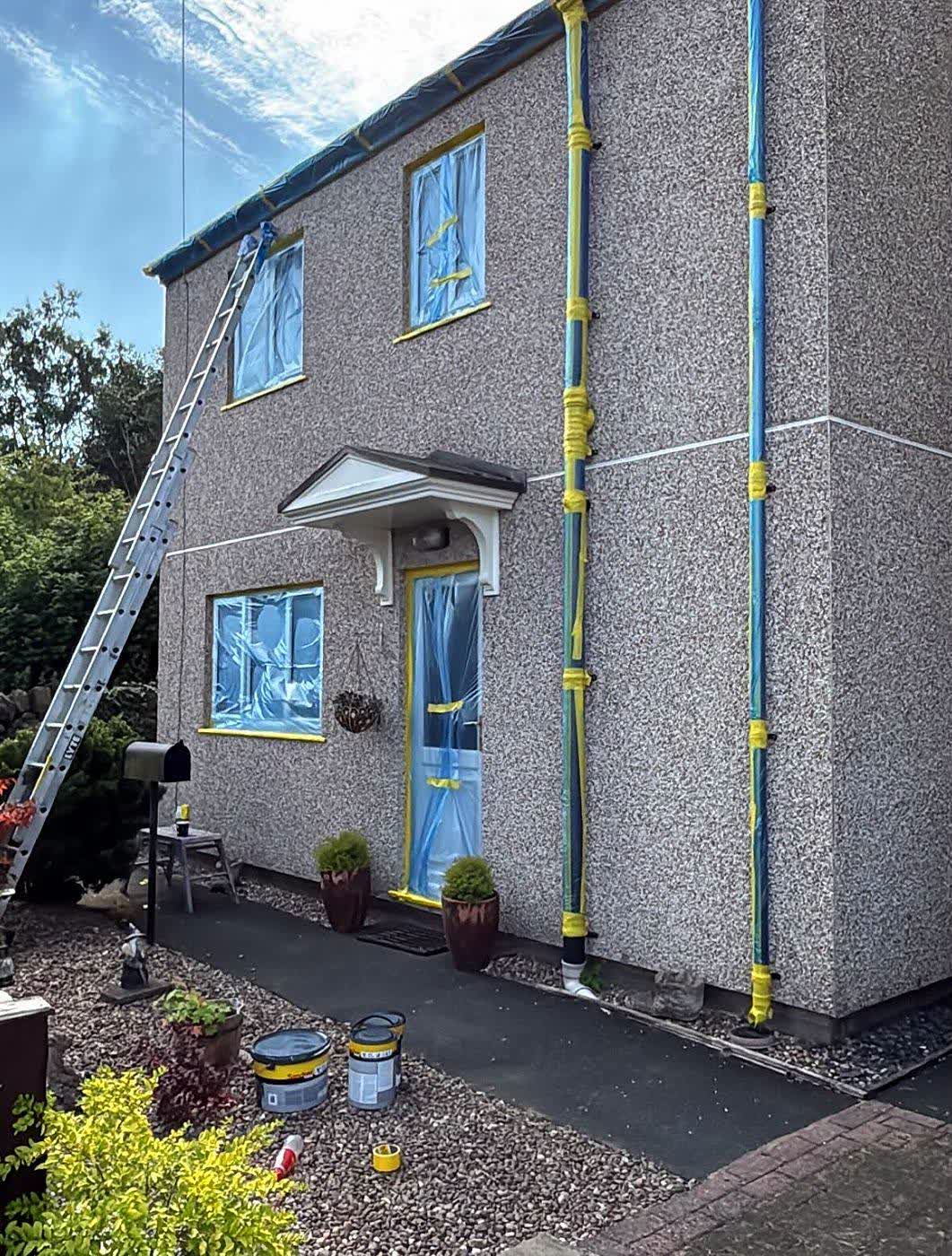 Downpipes and windows taped, ready for primer