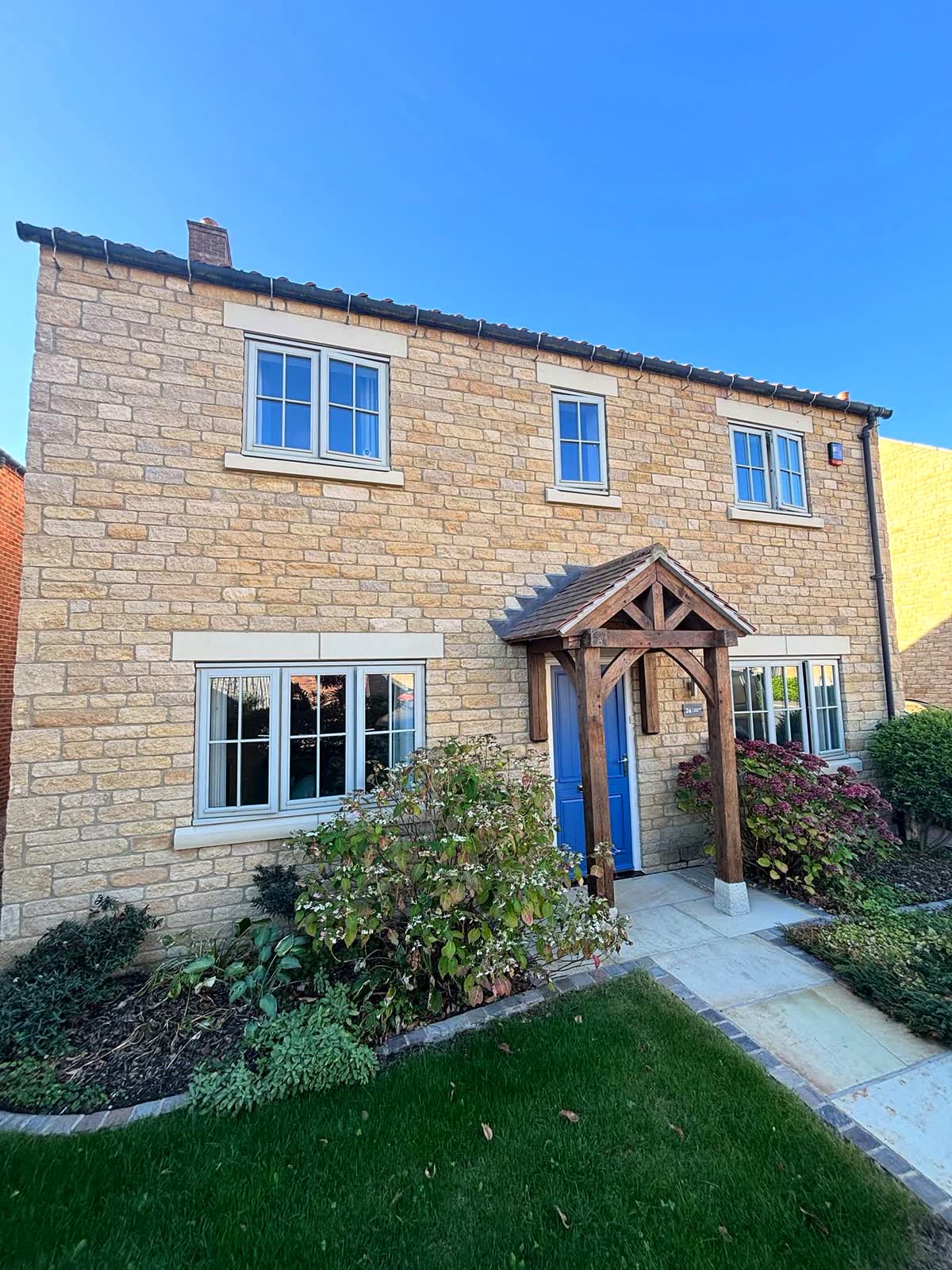 Stone house with wooden windows resprayed in cream white