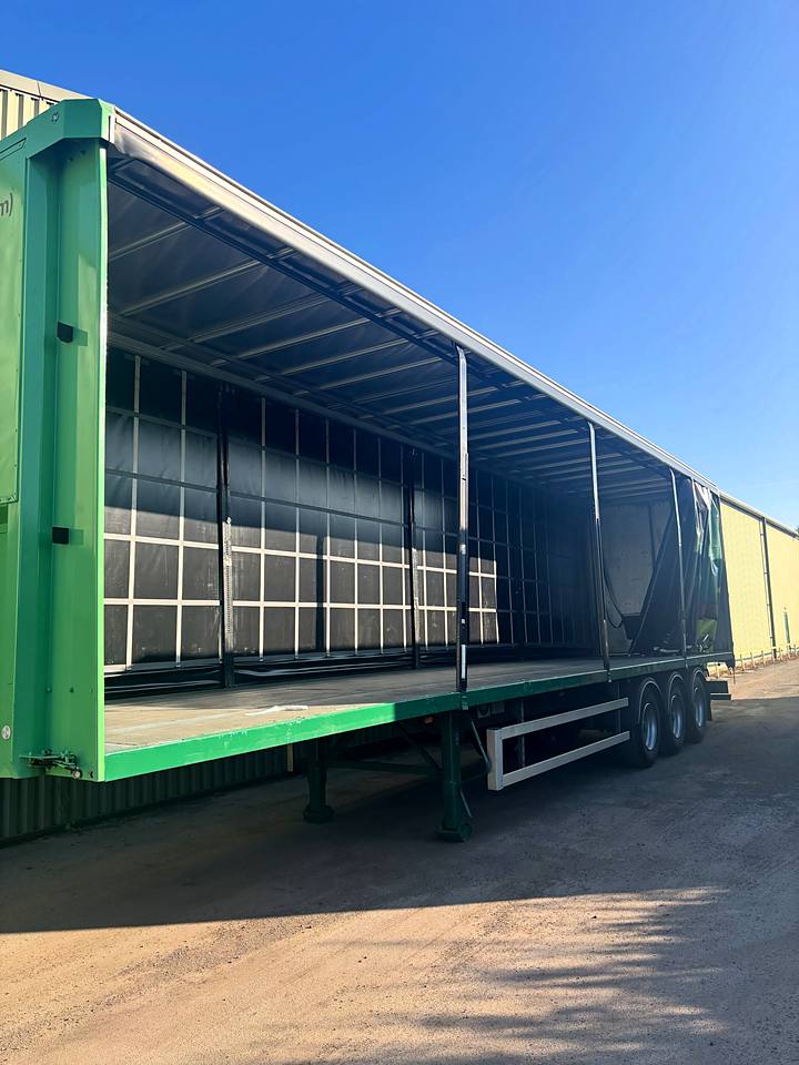 Curtain-side trailer chassis resprayed green for a business