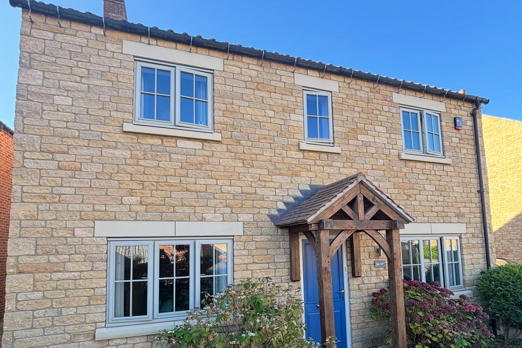 Stone house with its wooden windows freshly resprayed in cream
